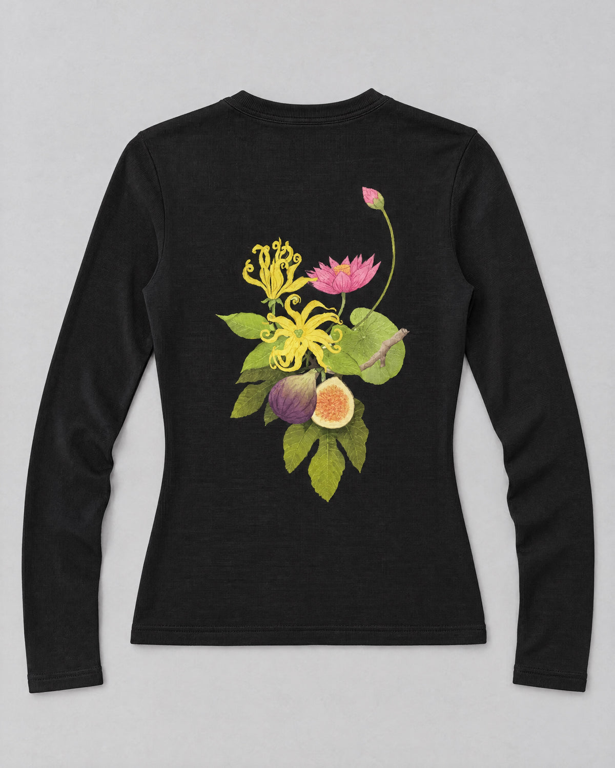 Back of the TIIN BABY TEE black top laid flat with botanical artwork.