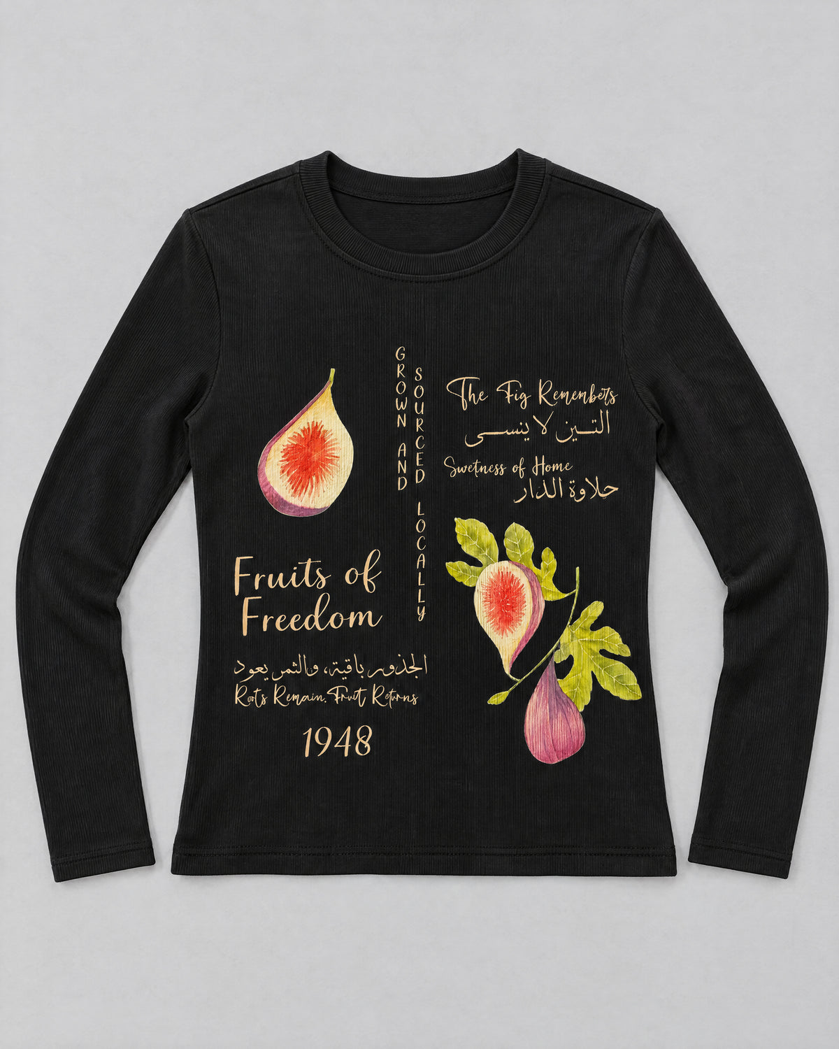 TIIN BABY TEE black long-sleeve top laid flat, with fig artwork and cream Arabic and English lettering.
