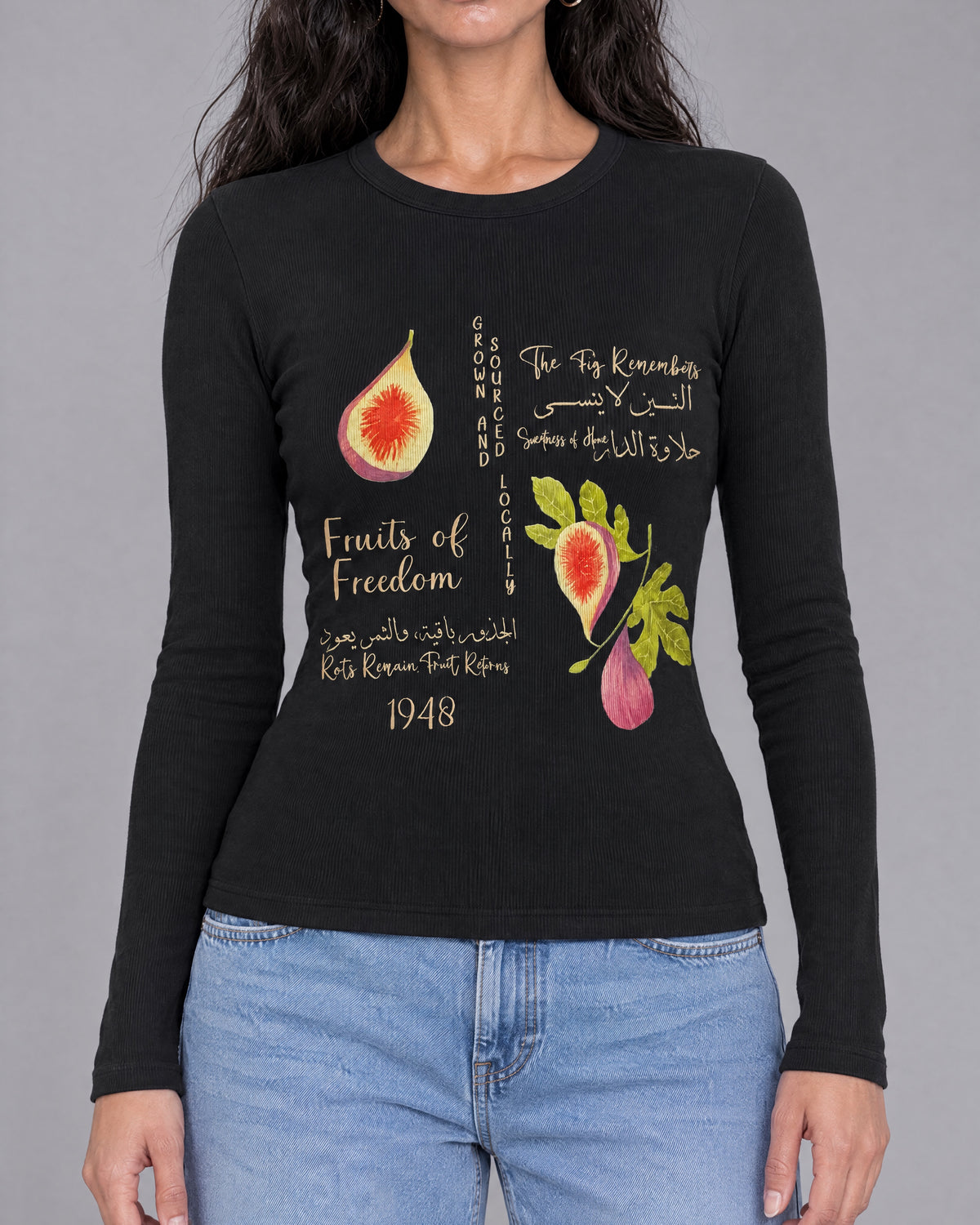 Close front view of TIIN BABY TEE fig illustrations and cream Arabic and English lettering.